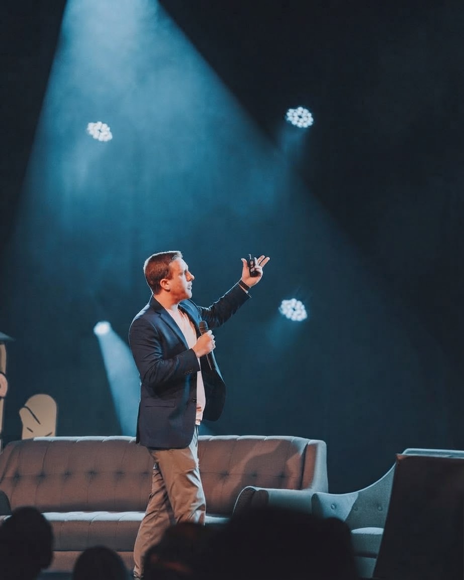 Jon Cheney speaking under stage spotlights